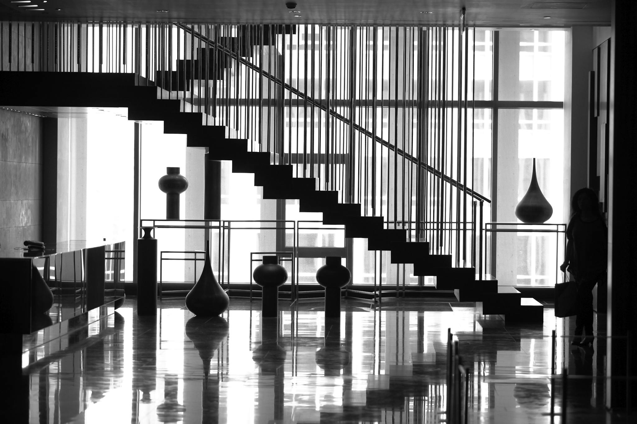 Interior of contemporary spacious hallway with staircase against big window