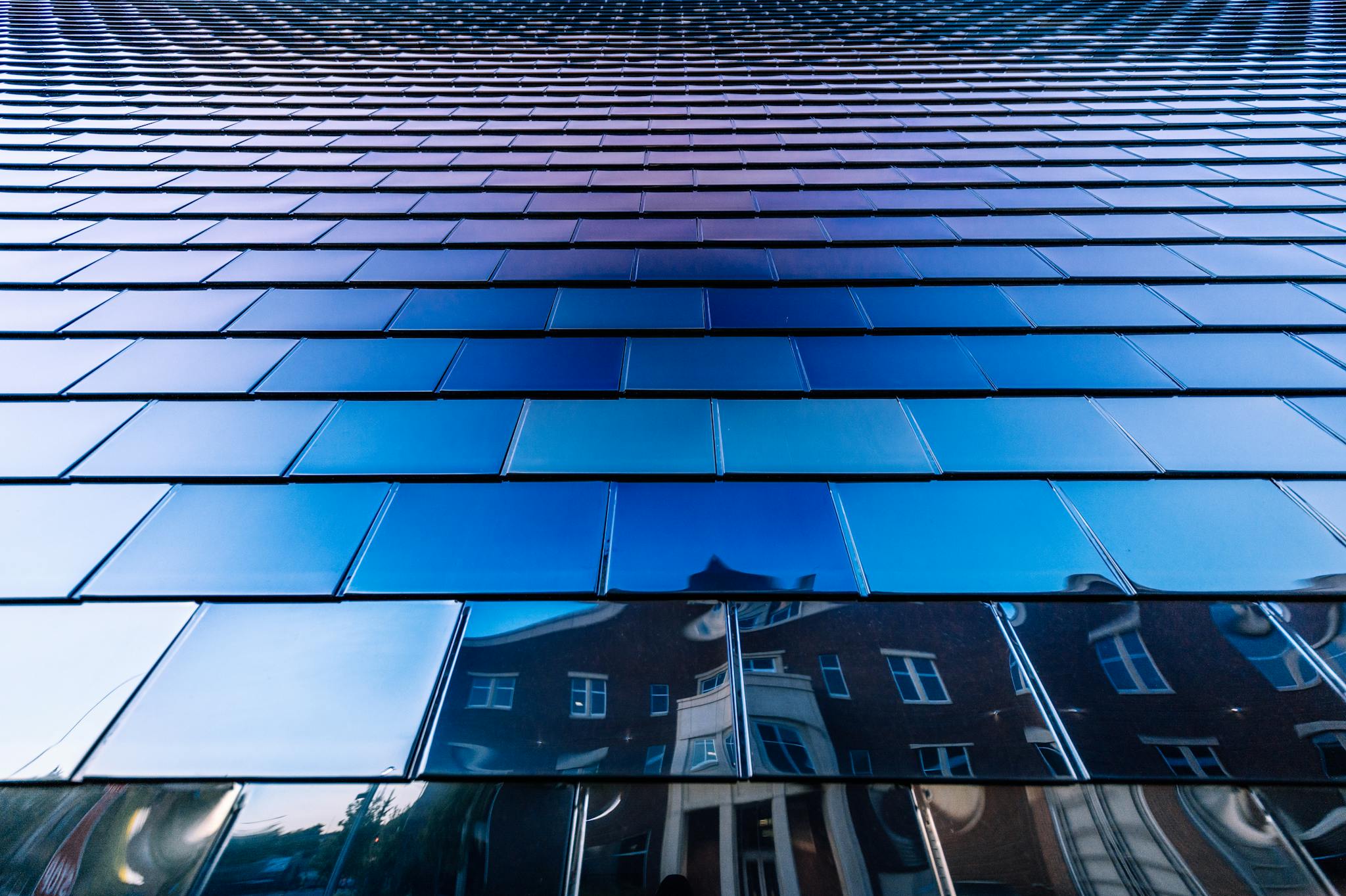 Mirrored facade of modern geometric building